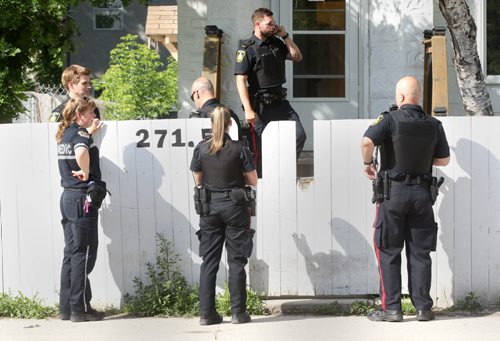 Police are gathering at a home at 271.5 Selkirk Ave between Charles and Main St Friday evening, and appear to be guarding a crime scene.- See Randy Turner story- June 27, 2014   (JOE BRYKSA / WINNIPEG FREE PRESS)