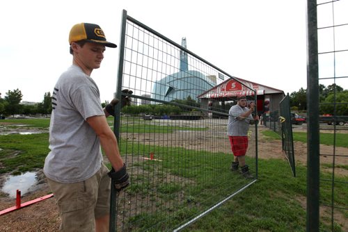 Forks site staff set up for Canada Day celebrations on Saturday afternoon despite the intermittent rain showers.  Standup photo   June 28, 2014 Ruth Bonneville / Winnipeg Free Press