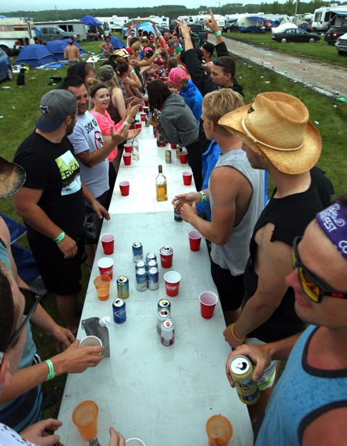 DAUPHIN'S COUNTRYFEST - SATURDAY -Festival goers killed some time during a rainy afternoon by drinking. This drinking game was by far the biggest seen in the campground. Flip Cup. BORIS MINKEVICH / WINNIPEG FREE PRESS  June 27, 2014