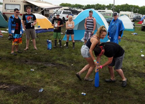 DAUPHIN'S COUNTRYFEST - SATURDAY -Festival goers killed some time during a rainy afternoon by drinking. This drinking game was called beer bat. You fill the bat with beer, blast if down, spin around as many times as seconds taken to chug it, and then try to hit one of three crushed beer cans. If you don't hit one then you drink again and start it all over again. BORIS MINKEVICH / WINNIPEG FREE PRESS  June 27, 2014