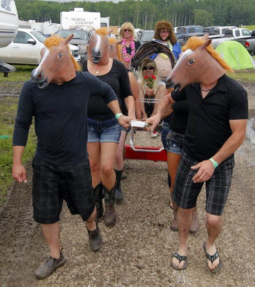DAUPHIN'S COUNTRYFEST - SATURDAY -Some festival goers horsing around. BORIS MINKEVICH / WINNIPEG FREE PRESS  June 27, 2014