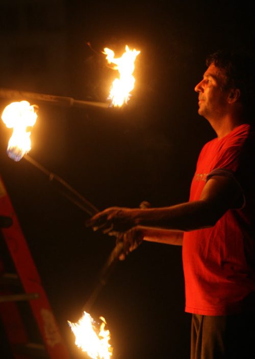 DAUPHIN'S COUNTRYFEST - FRIDAY -Festival sideshow entertainer juggles fire late at night. BORIS MINKEVICH / WINNIPEG FREE PRESS  June 27, 2014