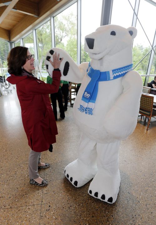 Stdup Zoo Mascot unveiled to the public . The Assiniboine Park Conservancy  , Journey to Churchill 's new mascot Winston made his first public appearance giving HI-5 to President and  ASsiniboine Zoo Conservency CEO Margaret Redmond  at the Qualico Family Centre just before noon Monday. The JtoC  is set to open Thurday  June 30 2014 / KEN GIGLIOTTI / WINNIPEG FREE PRESS