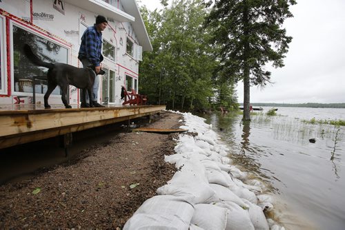 June 30, 2014 - 140630  -  A Otter Falls cottage owner (did not want name used) looks out over the water from the Winnipeg River which surrounds his sandbagged cottage Monday, June 30, 2014.  Manitoba and Saskatchewan experienced overland flooding and high river levels due to high rainfall over the past several days.  John Woods / Winnipeg Free Press