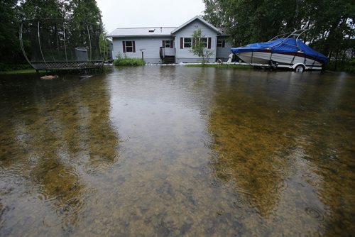 June 30, 2014 - 140630  -  A cottage is surrounded by water from the Winnipeg River at Otter Falls Monday, June 30, 2014.  Manitoba and Saskatchewan experienced overland flooding and high river levels due to high rainfall over the past several days.  John Woods / Winnipeg Free Press