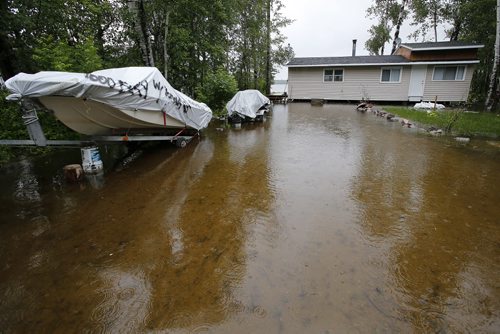 June 30, 2014 - 140630  -  A cottage is surrounded by water from the Winnipeg River at Otter Falls Monday, June 30, 2014.  Manitoba and Saskatchewan experienced overland flooding and high river levels due to high rainfall over the past several days.  John Woods / Winnipeg Free Press