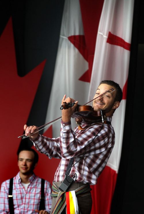Nic Messner and the Folk Group Ca Claque! warm up the crowd at the Lyric Stage at Assinaboine Park for a cool Canada Day celebration Tuesday. See story.  July 1, 2014 - (Phil Hossack / Winnipeg Free Press)