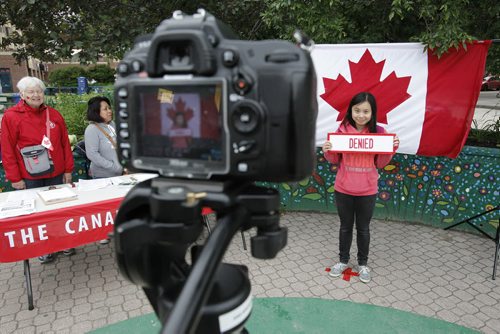 July 1, 2014 - 140701  -  Cheryl Fung poses for her photo after taking The Canada Challenge and being denied access to Canada during Canada Day celebrations in Osborne Village in Winnipeg Tuesday, July 1, 2014.   John Woods / Winnipeg Free Press
