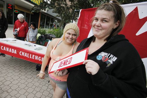 July 1, 2014 - 140701  -  Marcianna Mullin and Samantha Rapinchuck pose for their photo after taking The Canada Challenge and being denied access to Canada during Canada Day celebrations in Osborne Village in Winnipeg Tuesday, July 1, 2014.   John Woods / Winnipeg Free Press