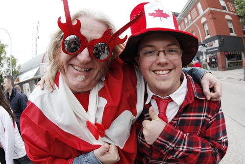 July 1, 2014 - 140701  -  Patrick Boggs and his son Zak were out celebrating during Canada Day in Osborne Village in Winnipeg Tuesday, July 1, 2014.   John Woods / Winnipeg Free Press