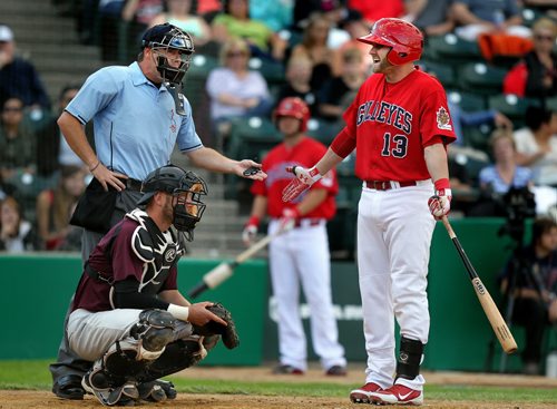 Winnipeg Goldeye Josh Mazzola expreses his frustration with Home Base Umpire Bryan Childe's call Wednesday evening. Kansas City T-Bone catcher Brian Erie stays low and to the outside of the disagreement at Shaw Park. July 2, 2014 - (Phil Hossack  / Winnipeg Free Press)