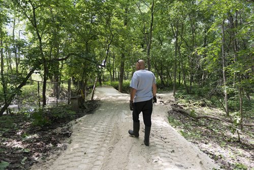 St. Francis resident Stephen Burdy walks along the dike he has built in his backyard to prevent severe flooding he is expecting this year. Sarah Taylor / Winnipeg Free Press