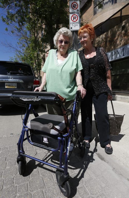 LOCAL  LOADING ZONE CHANGE - Fred Douglas Place- The city is  changing the loading zone in front of the building to metered parking, so the photo would need to be outside in front of Fred Douglas.Linda Lindsay and her 86-year-old mom  Peggy Lindsay with walker who lives at  Fred Douglas Place, 333 VaughanÄ® are against the change to meter parking .story by Jessica Botelho-Urbanski City Reporter July 3 2014 / KEN GIGLIOTTI / WINNIPEG FREE PRESS
