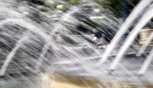 A cyclist passes by the fountain on the Manitoba Legislative grounds on a  beautiful Friday morning. For weather  story Wayne Glowacki / Winnipeg Free Press July 4  2014