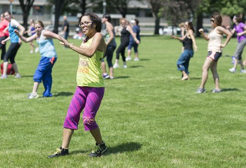 Zumba instructor Amy Thomas leads a group during a zumba class at Memorial Park Friday afternoon. Sarah Taylor / Winnipeg Free Press July 4th, 2014