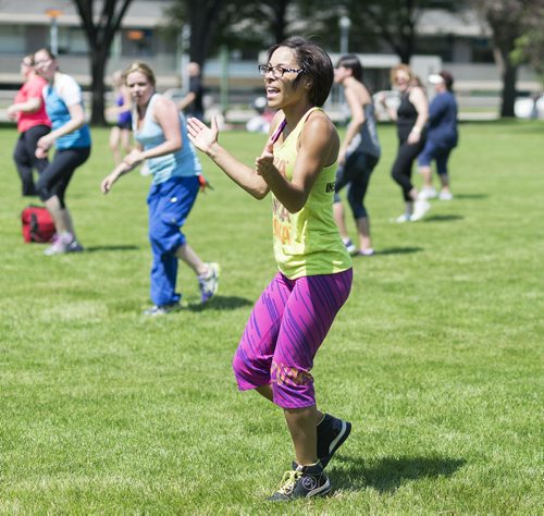 Zumba instructor Amy Thomas leads a group during a zumba class at Memorial Park Friday afternoon. Sarah Taylor / Winnipeg Free Press July 4th, 2014