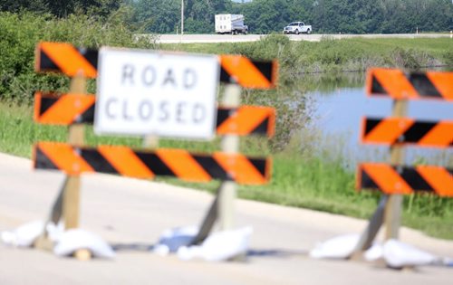 Vehicles from the Province of Manitoba sit on the road at the Hoop and Holler Bend, Saturday, July 5, 2014. (TREVOR HAGAN/WINNIPEG FREE PRESS)