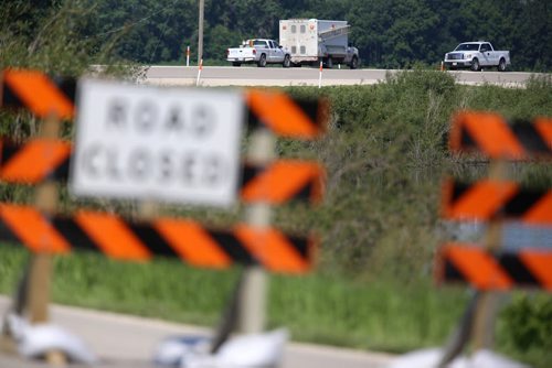 Vehicles MTS sit on the road at the Hoop and Holler Bend, Saturday, July 5, 2014. (TREVOR HAGAN/WINNIPEG FREE PRESS)