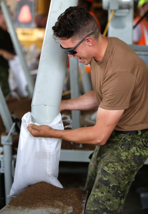 Soldiers from CFB Shilo, who along with members of the Portage la Prairie Municipality, were filling sandbags at the Portage Yard, Saturday, July 5, 2014. (TREVOR HAGAN/WINNIPEG FREE PRESS)