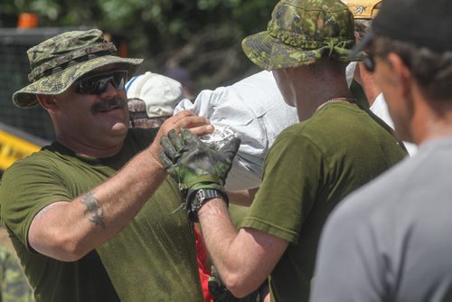 Sargent Kevin Gouthro a soldier from CFB Shilo and volunteers help fortify Kevin Van Camp's home near St. Francois Xavier Sunday afternoon. 140706 - Sunday, July 06, 2014 -  (MIKE DEAL / WINNIPEG FREE PRESS)