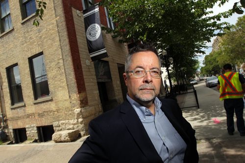 LOCAL - John Giavedoni, Executive Director of RESIDENTS OF THE EXCHANGE DISTRICT (R:ED) poses at the end of Market street where Union Sound Hall is right across a condo place. DAN LETT story. BORIS MINKEVICH / WINNIPEG FREE PRESS  July 7, 2014