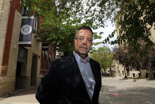 LOCAL - John Giavedoni, Executive Director of RESIDENTS OF THE EXCHANGE DISTRICT (R:ED) poses at the end of Market street where Union Sound Hall is right across a condo place. DAN LETT story. BORIS MINKEVICH / WINNIPEG FREE PRESS  July 7, 2014