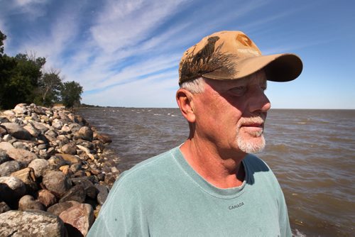 East Delta Beach resident Dennis Nodrick looks at Lake Manitoba Monday morning. - The west side of Delta Beach has been evacuated yesterday- See Adam Wazny story- July 07, 2014   (JOE BRYKSA / WINNIPEG FREE PRESS)