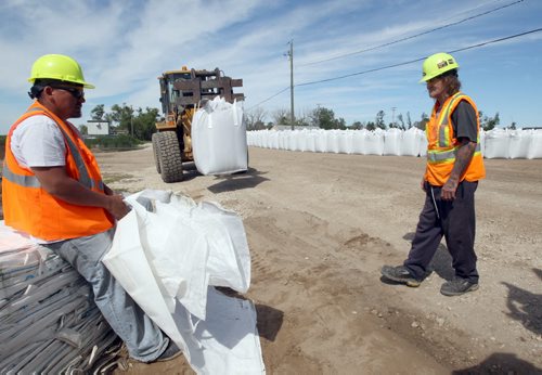 Crews are erecting super sand bags at the East end of Delta Beach Monday as protection of the road for residents in case of a required flood evacuation- The west side of Delta Beach has been evacuated yesterday- See Adam Wazny story- July 07, 2014   (JOE BRYKSA / WINNIPEG FREE PRESS)