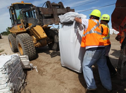 Crews are erecting super sand bags at the East end of Delta Beach Monday as protection of the road for residents in case of a required flood evacuation- The west side of Delta Beach has been evacuated yesterday- See Adam Wazny story- July 07, 2014   (JOE BRYKSA / WINNIPEG FREE PRESS)