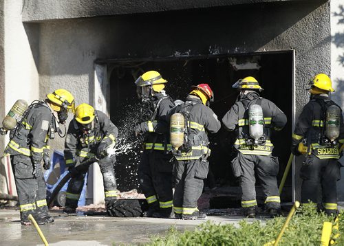 July 7, 2014 - 140707  -  Firefighters attend to a garage fire at 751 Park Blvd South Monday, July 7, 2014.  John Woods / Winnipeg Free Press