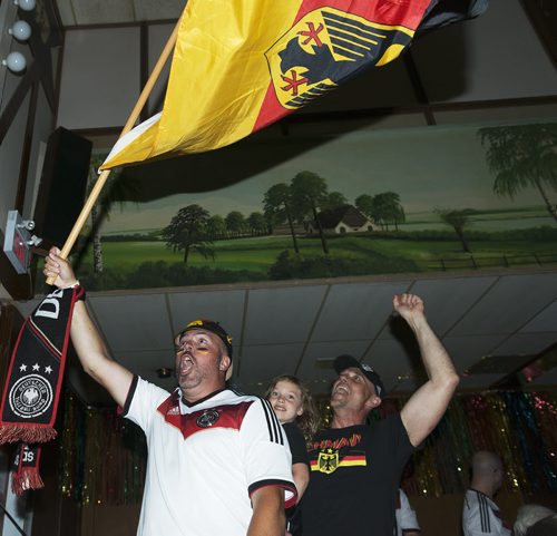 Rob Schaipe and Robert Schulz  with daughter Chanel cheer on as Germany scores five scores in the first 30 minutes of their game against Brazil. Sarah Taylor / Winnipeg Free Press July 8th, 2014
