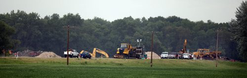 Heavy equipment waits the order to cut open the Hoop and Holler. July 8, 2014 - (Phil Hossack / Winipeg Free Press)