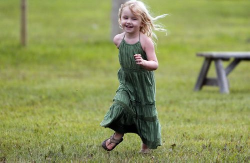 LOCAL/ENTERTAINMENT - Briar MacDonald,3, runs around as her mom and grandmother set up their craft sale tent. They are from Collingwood, Ontario. The popular music festival starts tomorrow. BORIS MINKEVICH / WINNIPEG FREE PRESS  July 8, 2014