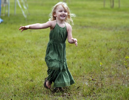LOCAL/ENTERTAINMENT - Briar MacDonald,3, runs around as her mom and grandmother set up their craft sale tent. They are from Collingwood, Ontario. The popular music festival starts tomorrow. BORIS MINKEVICH / WINNIPEG FREE PRESS  July 8, 2014
