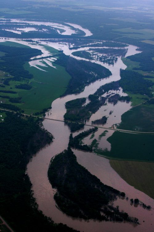 Heavy rains in western Manitoba and Saskatchewan recently have raised the level of the Assiniboine River causing it to overflow its banks flooding roads and farmers fields.   Aerial photo's of  flooded roads west of Portage la Prairie area.  July 08, 2014 Ruth Bonneville / Winnipeg Free Press