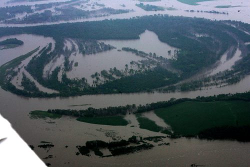 Heavy rains in western Manitoba and Saskatchewan recently have raised the level of the Assiniboine River causing it to overflow its banks flooding roads and farmers fields.   Aerial photo's of  flooded roads west of Portage la Prairie area.  July 08, 2014 Ruth Bonneville / Winnipeg Free Press