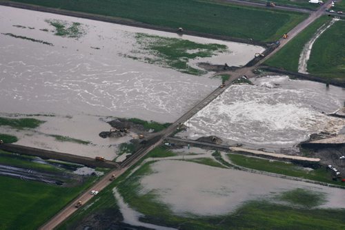 Heavy rains in western Manitoba and Saskatchewan recently have raised the level of the Assiniboine River causing it to overflow its banks flooding roads and farmers fields.   Aerial photo's north of  Portage la Prairie area of the manmade diversion leading to Lake Manitoba.   July 08, 2014 Ruth Bonneville / Winnipeg Free Press