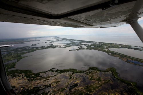 Heavy rains in western Manitoba and Saskatchewan recently have raised the level of the Assiniboine River causing it to overflow its banks flooding roads and farmers fields.   Aerial photo's of the south basin of Lake Manitoba area.  July 08, 2014 Ruth Bonneville / Winnipeg Free Press