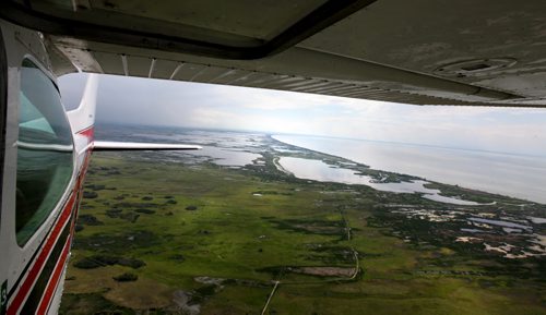 Heavy rains in western Manitoba and Saskatchewan recently have raised the level of the Assiniboine River causing it to overflow its banks flooding roads and farmers fields.   Aerial photo's of the south basin of Lake Manitoba area.  July 08, 2014 Ruth Bonneville / Winnipeg Free Press