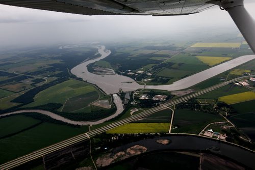 Heavy rains in western Manitoba and Saskatchewan recently have raised the level of the Assiniboine River causing it to overflow its banks flooding roads and farmers fields.   Aerial photo's of  Portage diversion dam just west of town where water is diverted north to Lake Manitoba.    July 08, 2014 Ruth Bonneville / Winnipeg Free Press