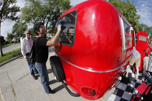 July 8, 2014 - 140708  -  Kelly Klick and her dad Jack polish her 1975 Boler camper Monday, July 8, 2014. The 1975 Boler camper is owned by  Kelly Klick and Tom McMahon and was restored by Kelly and her father Jack. John Woods / Winnipeg Free Press