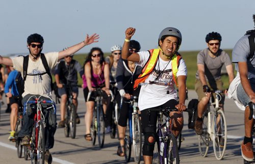 Winnipeg Folk Fest 2014 began with the bike ride to the park , hundreds of participants  rode their bikes to the Birds Hill Park to get priority entry  to the event . July 9 2014 / KEN GIGLIOTTI / WINNIPEG FREE PRESS