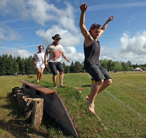Winnipeg Folk Fest 2014 Things are hopping at the festival camp ground  around a part time ramp and picnic table seating 22 . RtoL Cam Gilbert jumps off the sod  grass strip ramp  withSteven Geary  and Amos Bridgman.The day  began with the bike ride to the park , hundreds of participants  rode their bikes to the Birds Hill Park to get priority entry  to the event . July 9 2014 / KEN GIGLIOTTI / WINNIPEG FREE PRESS
