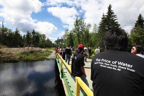 Residents of Shoal Lake 40 First Nation take part in event marking the 100th anniversary for the flooding of their land to provide water for the City of Winnipeg.  The flood disconnected them from the mainland except in the winter when the temporary bridge they are on connects them via a winter road.  The bridge is a temporary bridge that connects the community to a road to the mainland available in the winter only (winter road).  The community calls the road --Freedom Road, even though it was never finished. See Mary Agnes story. July 09, 2014 Ruth Bonneville / Winnipeg Free Press