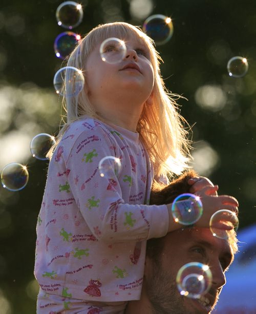 Elliette Fast points out bubbles atop her father Reynold's shoulders on the opening day of Winnipeg Folk Fest 2014 at Birds Hill Park. 140709 - Wednesday, July 09, 2014 - (Melissa Tait / Winnipeg Free Press)