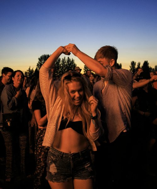 Festival goers dance to Bonnie Raitt's headlining set on the opening night of Winnipeg Folk Fest 2014 at Birds Hill Park. 140709 - Wednesday, July 09, 2014 - (Melissa Tait / Winnipeg Free Press)