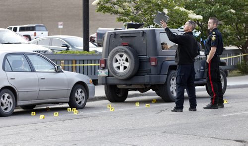 Wpg Police are investigating a crime scene  on Carlton Ave at Graham Mall the scene of an overnight shooting.There are video surveillance cameras in the area .   July 10 2014 / KEN GIGLIOTTI / WINNIPEG FREE PRESS