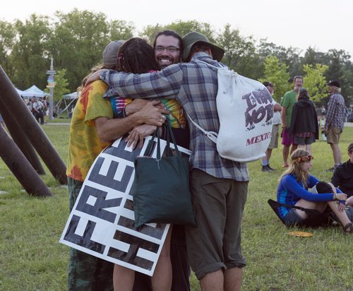 Greg Allan feels the love as he hands out free hugs at Folk Fest on Thursday. Sarah Taylor / Winnipeg Free Press July 10, 2014