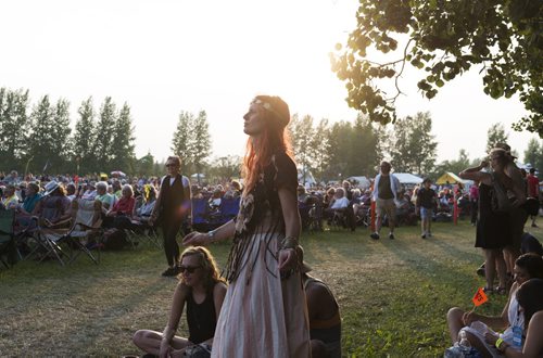 Chantal Dick attends Folk Fest for the fourth time. The Chic Gamine fan dances as they perform Thursday night. Sarah Taylor / Winnipeg Free Press July 10, 2014