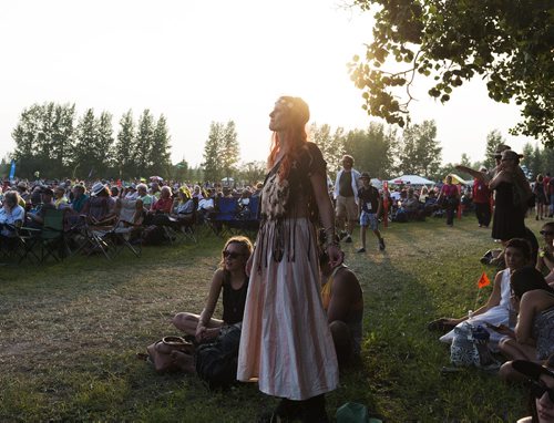 Chantal Dick attends Folk Fest for the fourth time. The Chic Gamine fan dances as they perform Thursday night. Sarah Taylor / Winnipeg Free Press July 10, 2014
